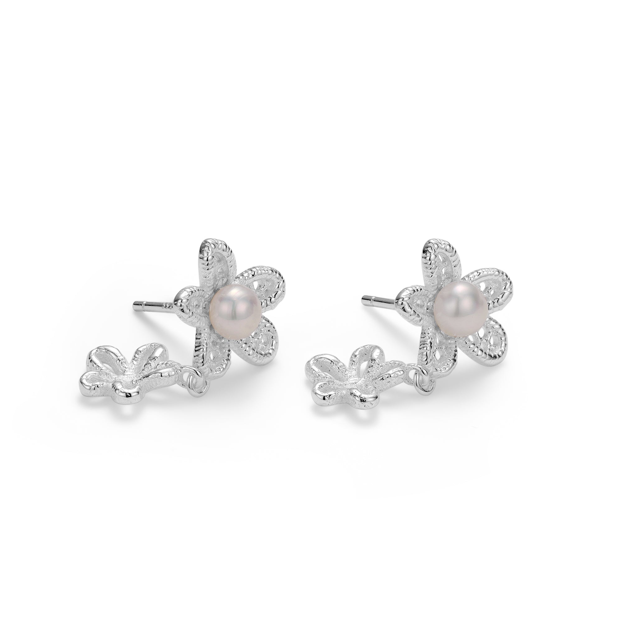 Flower-shaped earrings with pearl centers on a white background